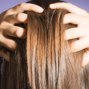 Woman massaging her scalp