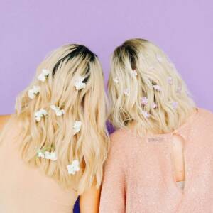 2 blonde girls with flowers in their hair