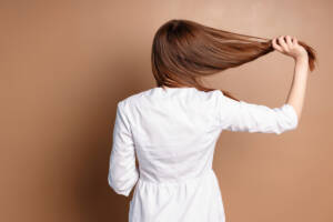 Brown hair color ideas: woman holding her hair