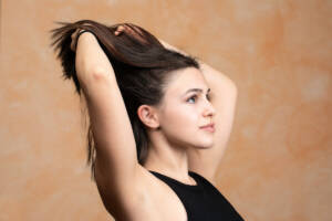 Woman combing her hair using her fingers