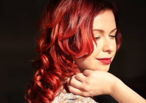 Woman with bright red, curly hair