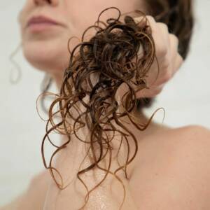 Woman holding her curly hair