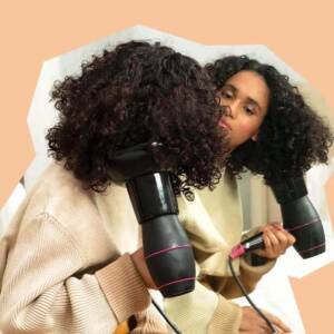 Woman drying her hair using a blow dryer